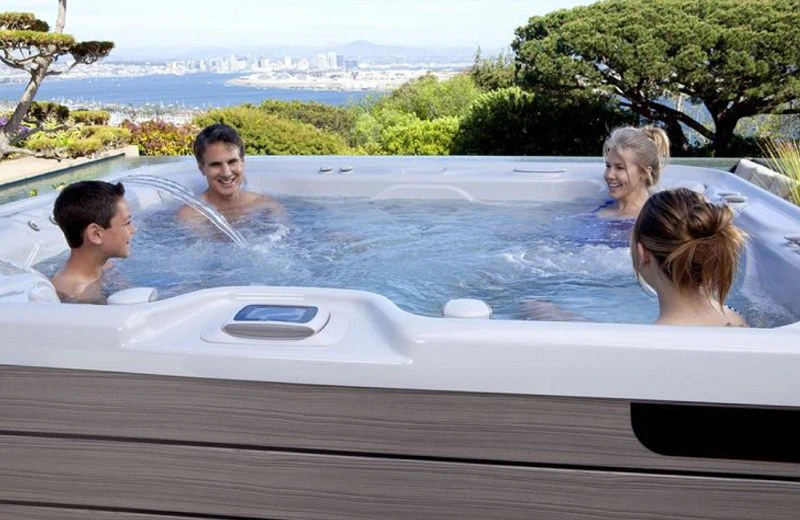Four guests happily soaking in the hot tub Four guests happily soaking in the hot tub